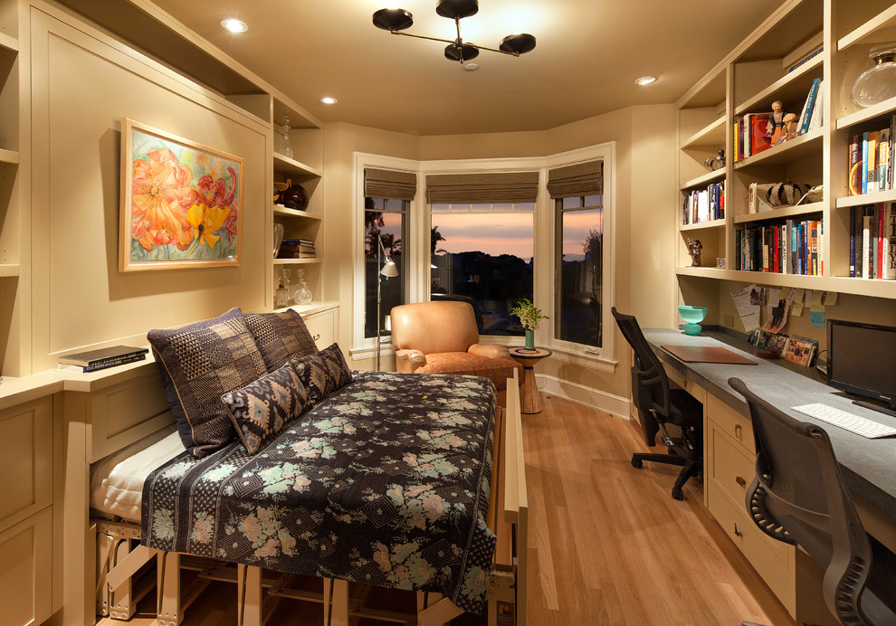 Mid-sized traditional study room in Santa Barbara with beige walls, light hardwood floors and a built-in desk.
