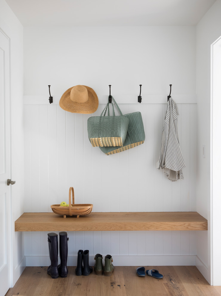 Inspiration for a country mudroom in San Francisco with white walls, medium hardwood floors and brown floor.