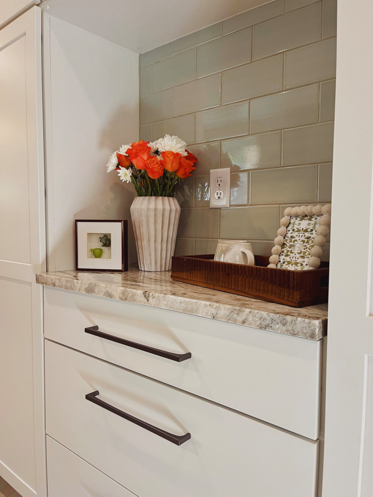 Eat-in kitchen - mid-sized transitional l-shaped vinyl floor and beige floor eat-in kitchen idea with a farmhouse sink, shaker cabinets, medium tone wood cabinets, quartzite countertops, green backsplash, ceramic backsplash, stainless steel appliances, no island and beige countertops