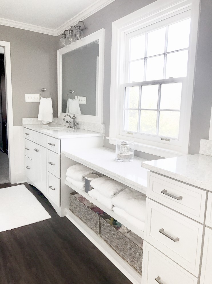 Photo of a large transitional master bathroom in Philadelphia with recessed-panel cabinets, white cabinets, an undermount tub, a double shower, a two-piece toilet, gray tile, porcelain tile, grey walls, vinyl floors, an undermount sink, engineered quartz benchtops, brown floor and a hinged shower door.