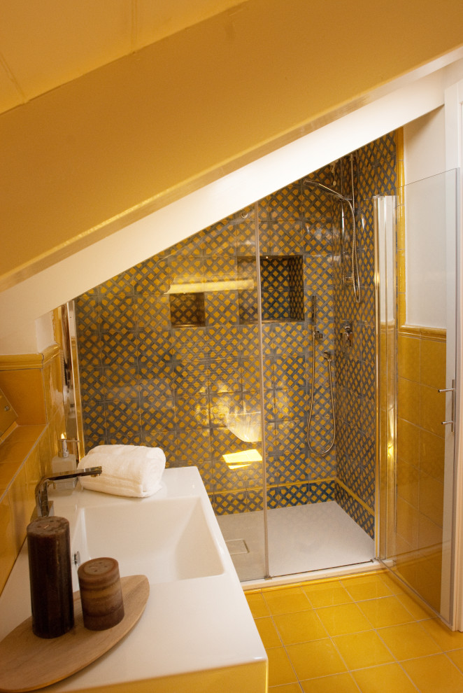 Small mediterranean 3/4 bathroom in Other with a double shower, a wall-mount toilet, yellow tile, ceramic tile, yellow walls, ceramic floors, an integrated sink, yellow floor, a hinged shower door, white benchtops and a single vanity.