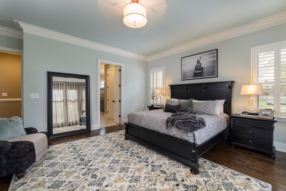 Photo of a large transitional master bedroom in Raleigh with grey walls, dark hardwood floors, no fireplace and brown floor.