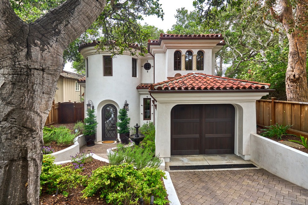 Mediterranean two-storey white house exterior in San Francisco with a hip roof and a tile roof.