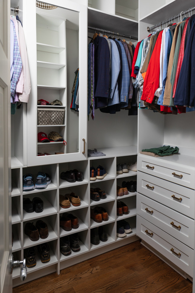 Photo of a large transitional men's walk-in wardrobe in Atlanta with shaker cabinets, white cabinets, dark hardwood floors and brown floor.