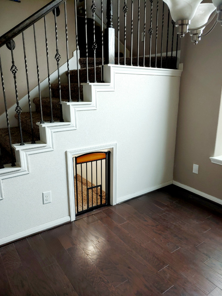 Inspiration for a small traditional staircase in Houston with metal railing.