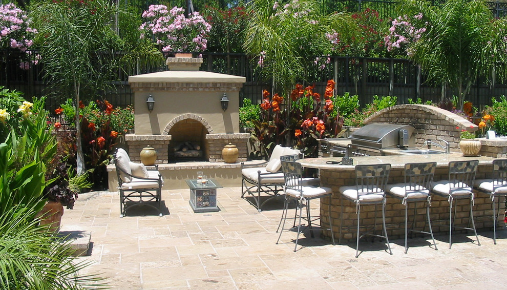 Small traditional backyard patio in Boise with an outdoor kitchen, stamped concrete and no cover.