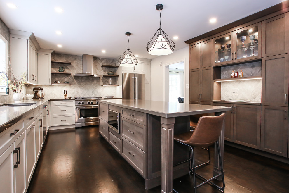 Large transitional l-shaped dark wood floor and brown floor eat-in kitchen photo in Toronto with an undermount sink, shaker cabinets, gray cabinets, quartz countertops, gray backsplash, porcelain backsplash, stainless steel appliances and an island