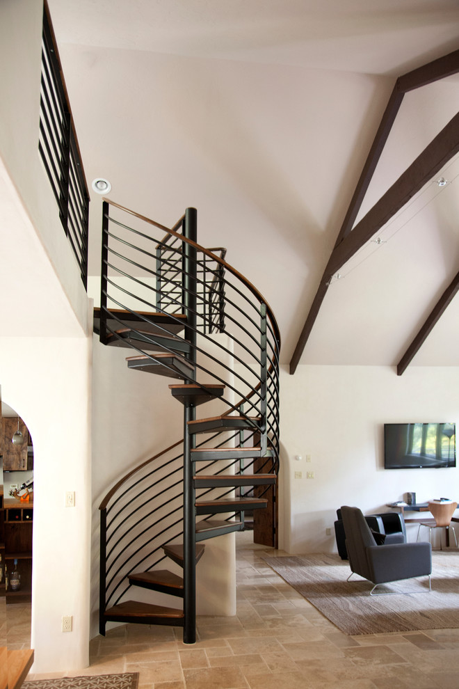 Photo of a mid-sized wood spiral staircase in Albuquerque with open risers.