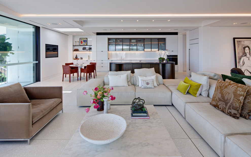 Modern open concept living room in Sydney with white walls and grey floor.