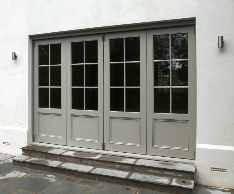Photo of a traditional entryway in Hampshire with a pivot front door and a gray front door.