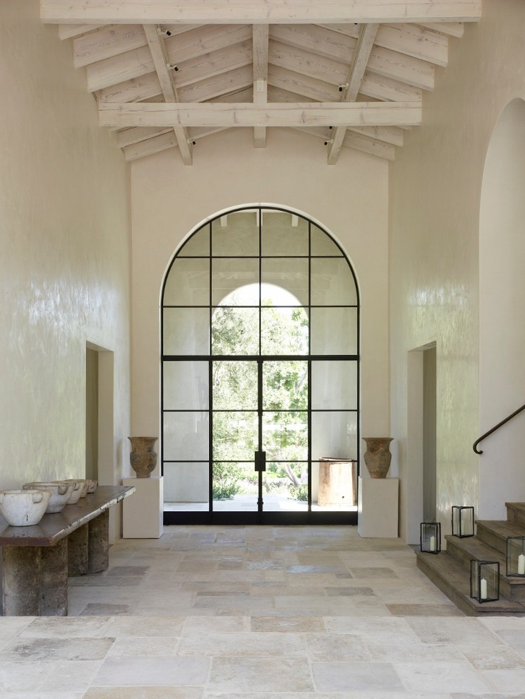 Inspiration for a large mediterranean entryway in San Diego with white walls.
