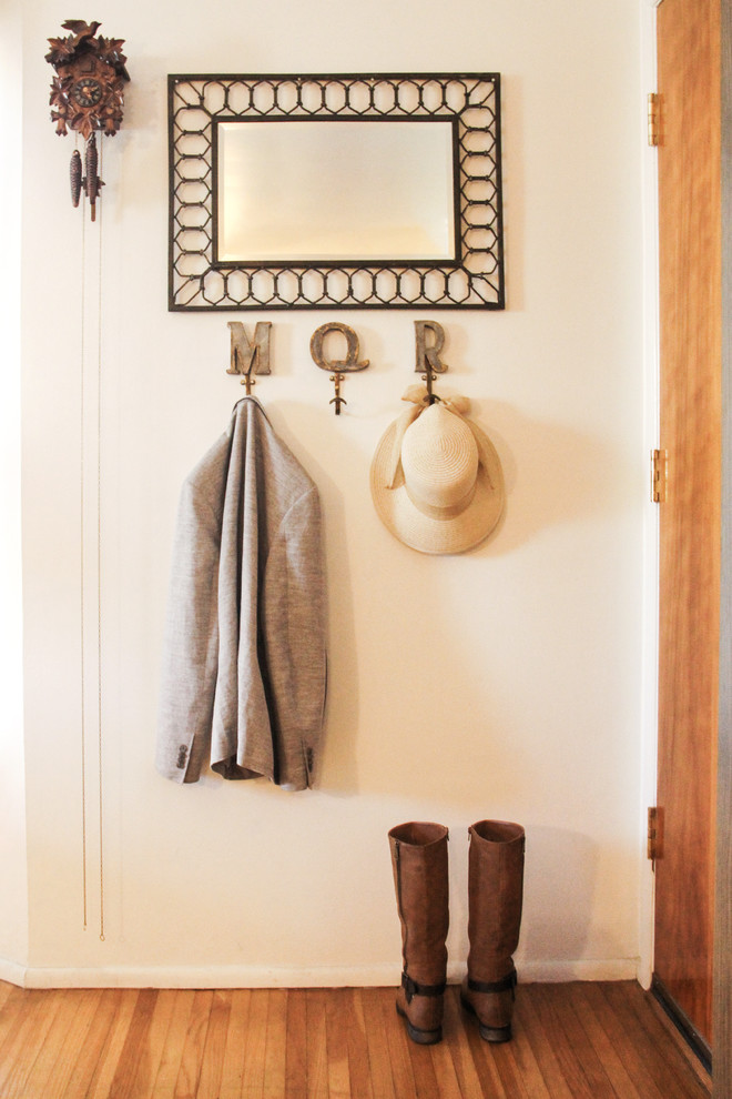 Small transitional medium tone wood floor front door photo in Los Angeles with white walls and a medium wood front door