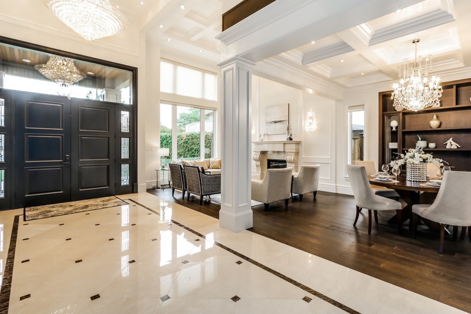 Large transitional front door in Vancouver with beige walls, porcelain floors, a double front door, a black front door and beige floor.