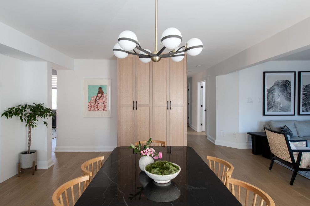 Mid-sized transitional u-shaped light wood floor and brown floor eat-in kitchen photo in Ottawa with an undermount sink, shaker cabinets, white cabinets, quartz countertops, white backsplash, quartz backsplash, stainless steel appliances, a peninsula and white countertops