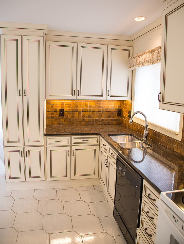 Photo of a mid-sized transitional u-shaped kitchen in Baltimore with an undermount sink, recessed-panel cabinets, white cabinets, granite benchtops, metallic splashback, white appliances and no island.