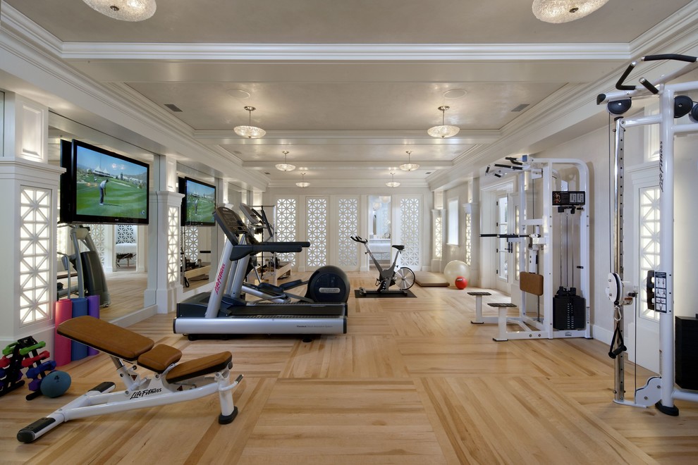 This is an example of an expansive contemporary multipurpose gym in Orange County with white walls and light hardwood floors.