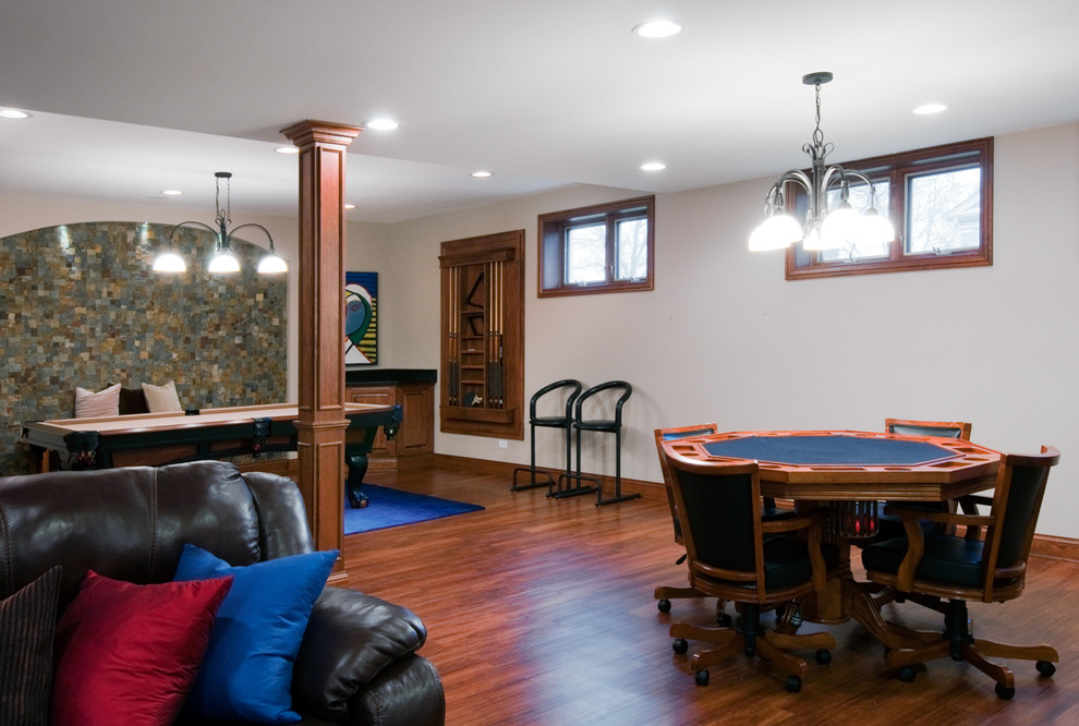 Photo of a mid-sized traditional open concept family room in Chicago with a game room, white walls, medium hardwood floors and brown floor.