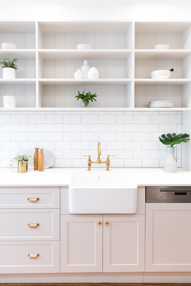Design ideas for a mid-sized transitional l-shaped eat-in kitchen in Melbourne with a farmhouse sink, shaker cabinets, grey cabinets, quartz benchtops, white splashback, subway tile splashback, stainless steel appliances, medium hardwood floors and with island.