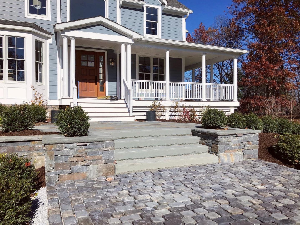 Photo of a contemporary backyard full sun driveway for spring in New York with with path and natural stone pavers.