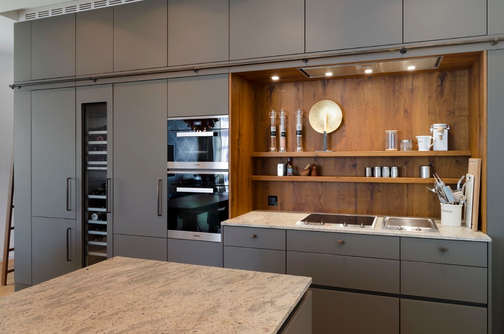 Inspiration for a large galley open plan kitchen in Hamburg with flat-panel cabinets, grey cabinets, granite benchtops, multi-coloured splashback, timber splashback, medium hardwood floors and with island.
