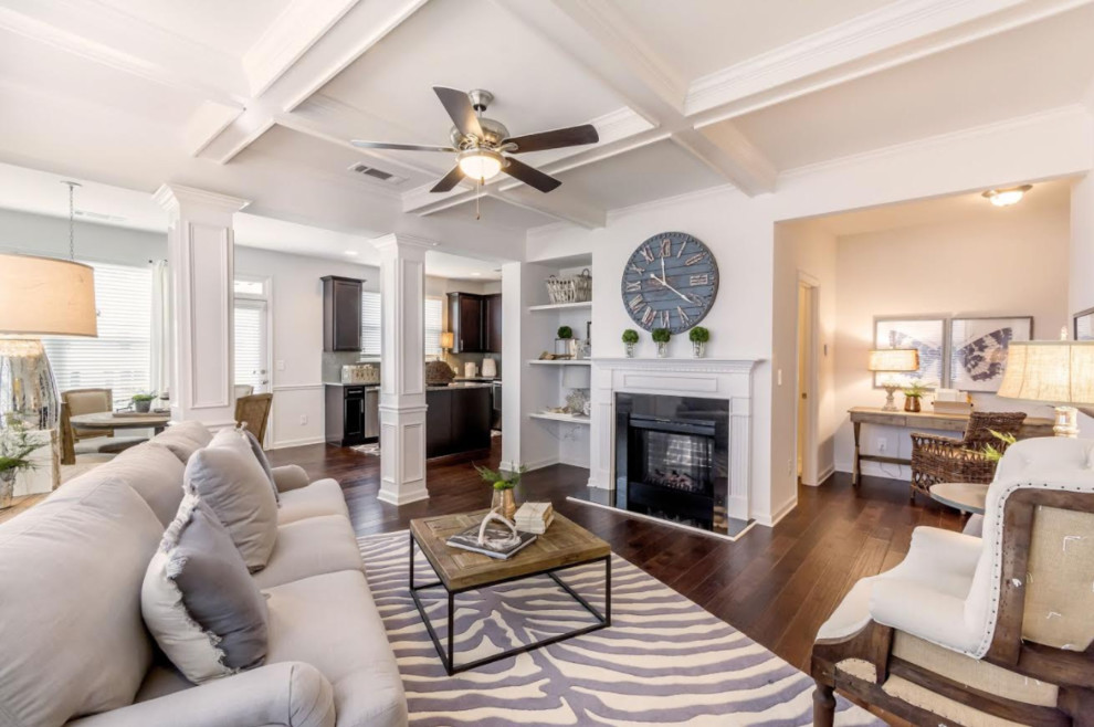 This is an example of a mid-sized transitional open concept living room in Atlanta with white walls, dark hardwood floors, a standard fireplace, a tile fireplace surround and brown floor.