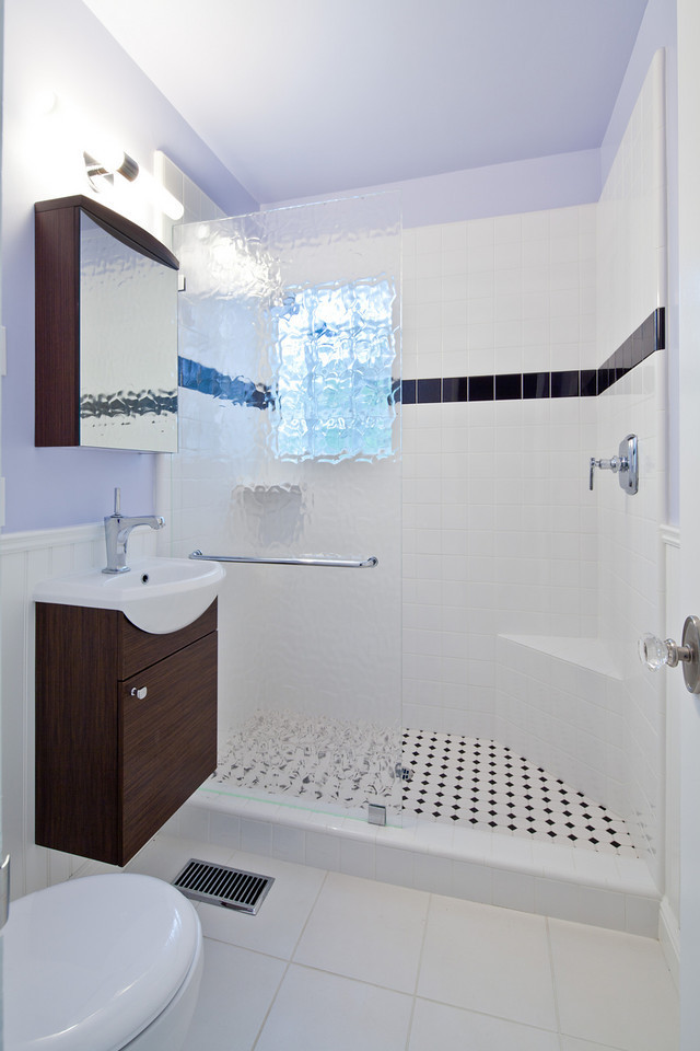 Inspiration for a mid-sized modern 3/4 bathroom in San Francisco with flat-panel cabinets, dark wood cabinets, an alcove shower, a two-piece toilet, black tile, black and white tile, white tile, subway tile, blue walls, ceramic floors and a wall-mount sink.