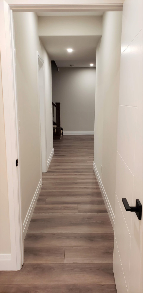Large transitional walk-out vinyl floor basement photo