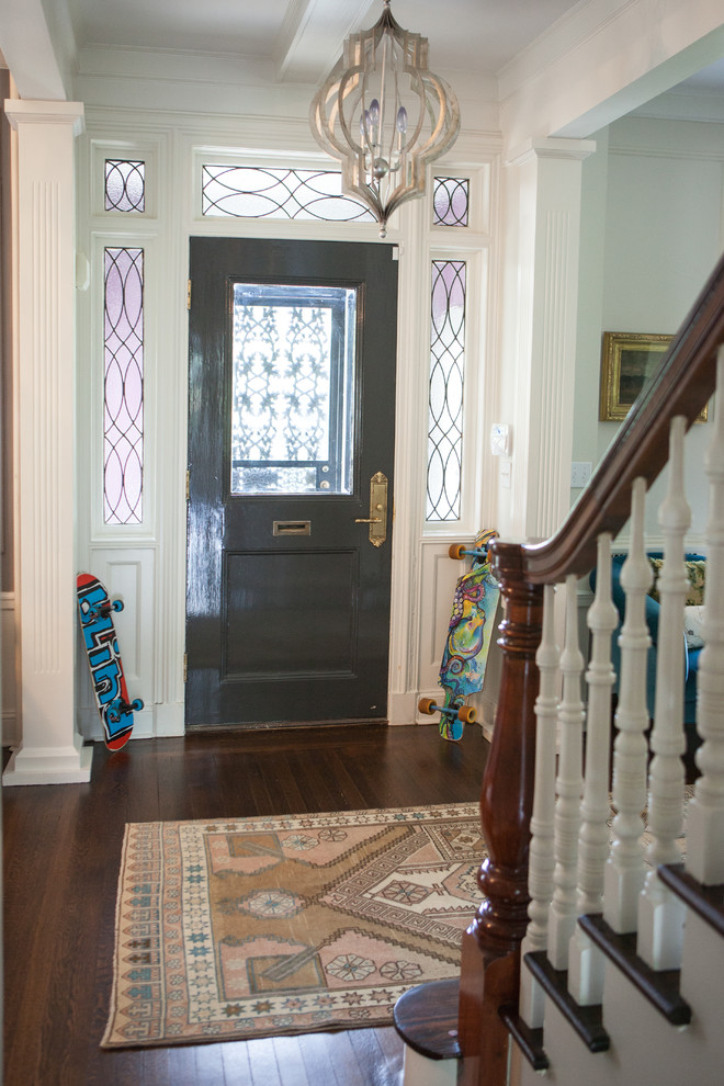 Photo of a mid-sized eclectic foyer in New York with white walls, dark hardwood floors, a double front door, a metal front door and pink floor.
