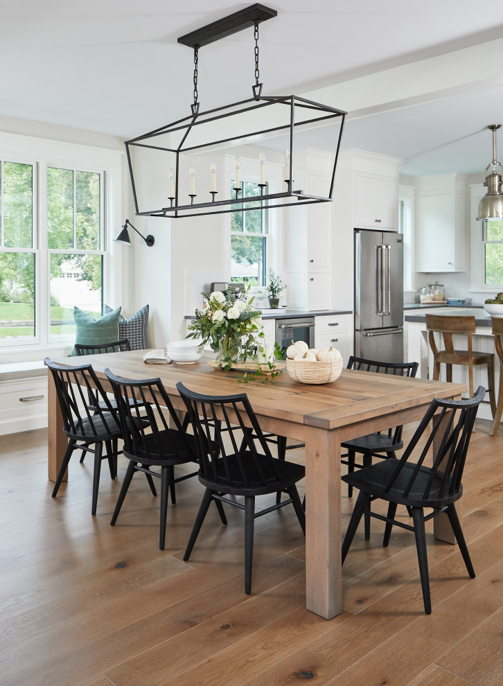 Photo of a mid-sized country open plan dining in Grand Rapids with white walls and medium hardwood floors.