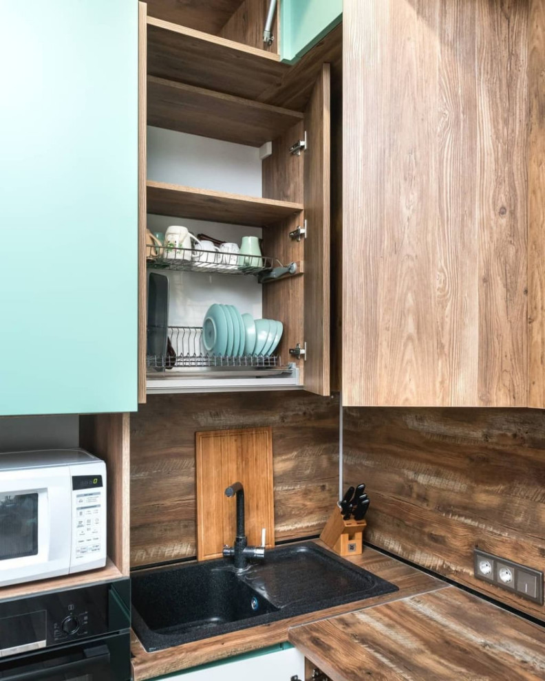 Inspiration for a small scandinavian l-shaped open plan kitchen in Moscow with a built-in sink, flat-panel cabinets, turquoise cabinets, wood worktops, brown splashback, wood splashback, black appliances, lino flooring, no island, brown floors and brown worktops.