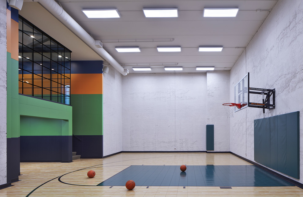 Large contemporary indoor sport court in Minneapolis with grey walls and beige floor.