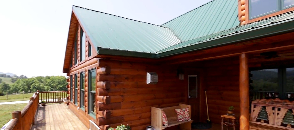 Deck - large rustic side yard balcony deck idea with a roof extension