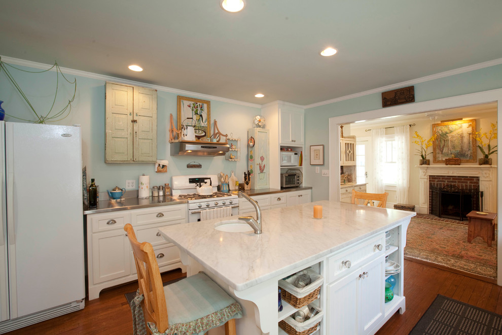 Traditional galley kitchen in Wilmington with an undermount sink, white cabinets and white appliances.