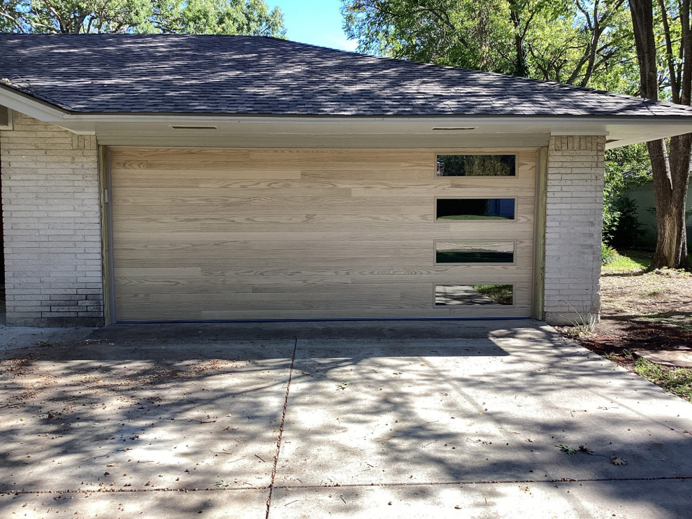 Inspiration for a large modern attached two-car garage in Dallas.