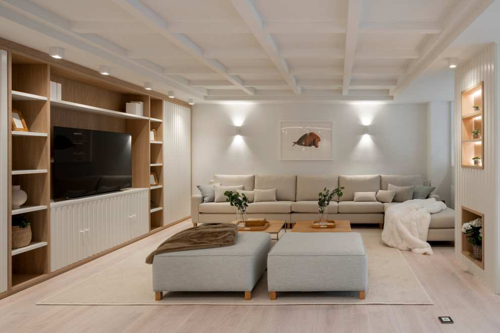 Large scandinavian open concept living room in Bilbao with a library, white walls, laminate floors, no fireplace, a built-in media wall and brown floor.