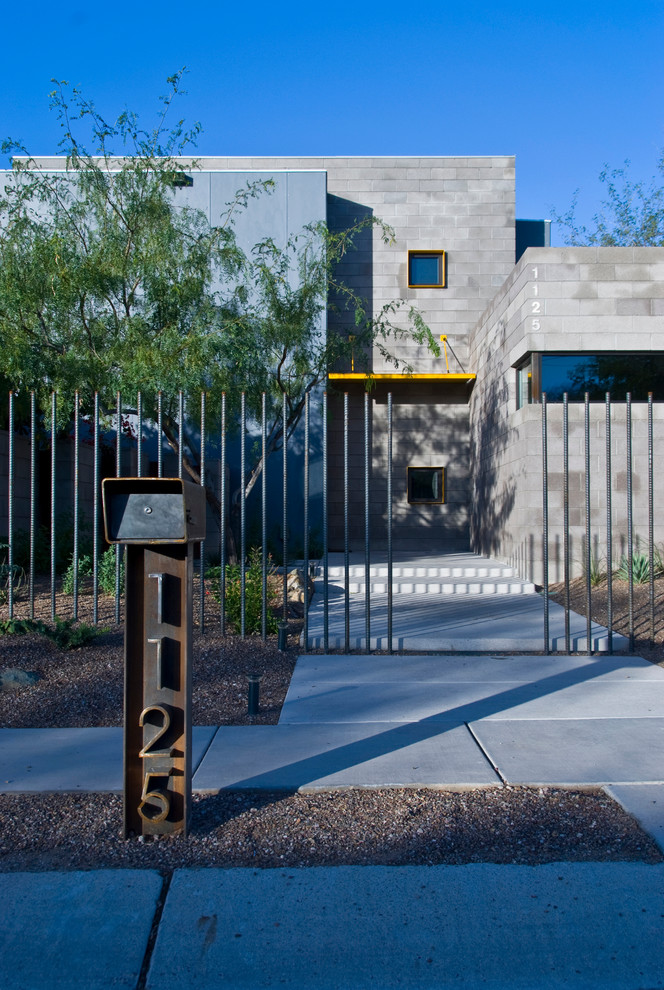 Inspiration for a mid-sized contemporary two-storey concrete apartment exterior in Phoenix.