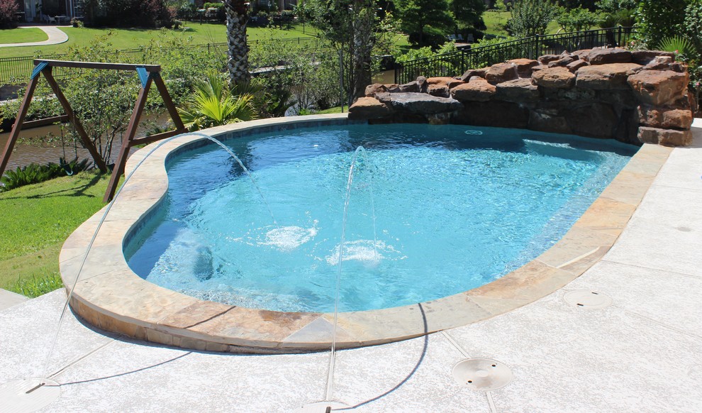 Example of a small transitional backyard concrete and custom-shaped pool design in Houston