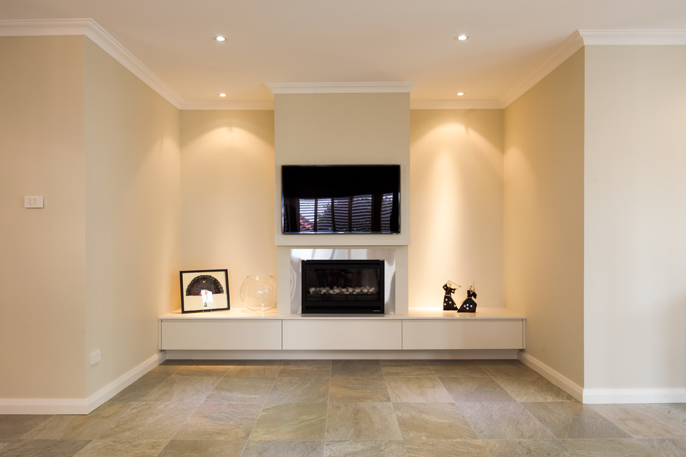 This is an example of a modern living room in Sydney with porcelain floors, a standard fireplace and a plaster fireplace surround.
