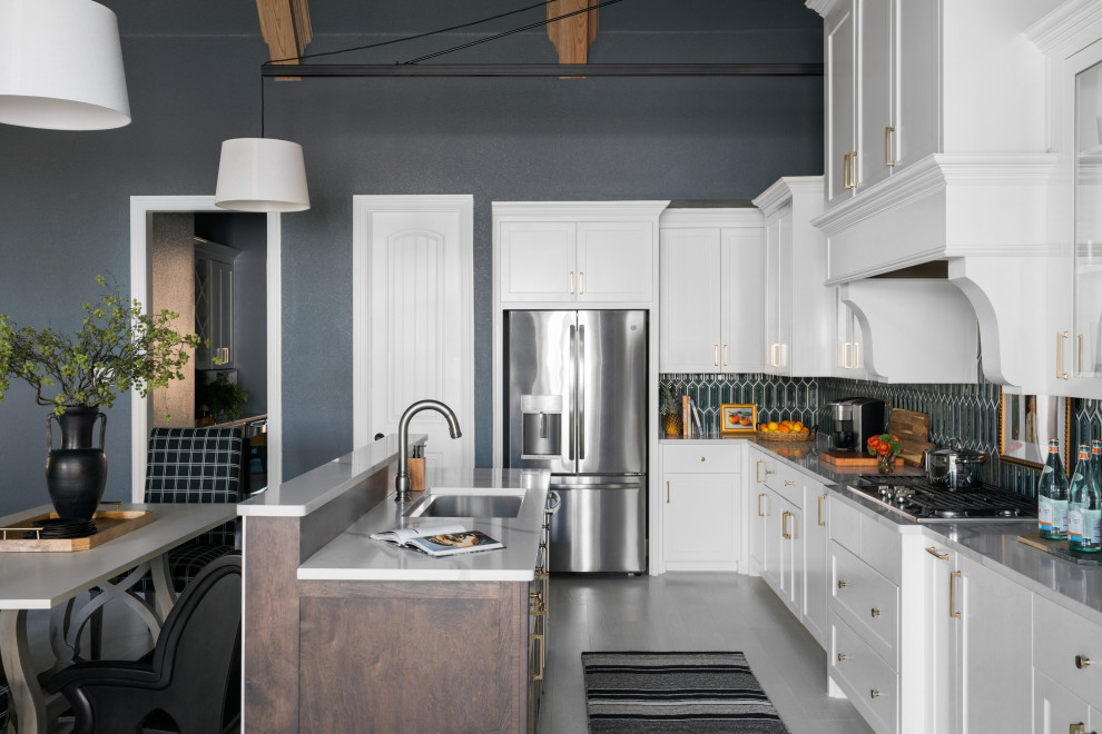 Design ideas for a large eclectic galley open plan kitchen in Chicago with raised-panel cabinets, white cabinets, green splashback, ceramic splashback, stainless steel appliances, light hardwood floors, with island, white floor and grey benchtop.
