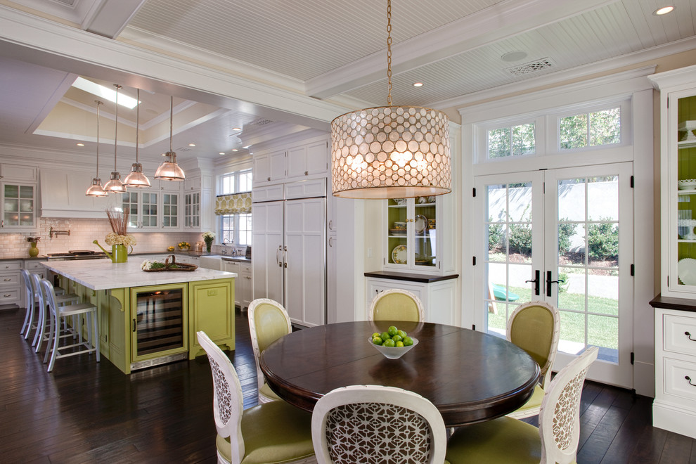 West Coast Hamptons - The kitchen, breakfast room and family room are all open to one another. The kitchen has a large twelve foot island topped with Calacatta marble and features a roll-out kneading table, and room to seat the whole family. The sunlight breakfast room opens onto the patio which has a built-in barbeque, and both bar top seating and a built in bench for outdoor dining. The large family room features a cozy fireplace, TV media, and a large built-in bookcase. The adjoining craft room is separated by a set of pocket french doors; where the kids can be visible from the family room as they do their homework.