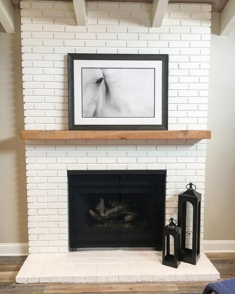Inspiration for a large guest bedroom in Denver with grey walls, laminate floors, a standard fireplace, a brick fireplace surround and grey floor.