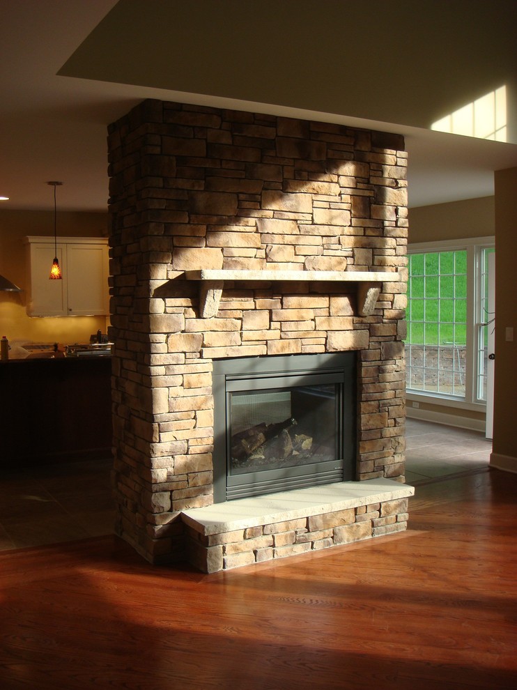 Design ideas for an open concept family room in Boston with a two-sided fireplace and a stone fireplace surround.