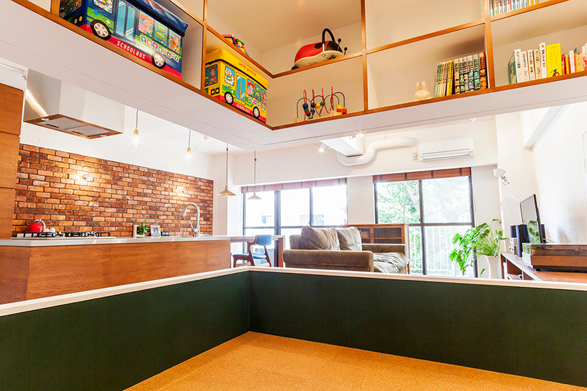 This is an example of a small arts and crafts gender-neutral kids' room in Tokyo with green walls and cork floors.