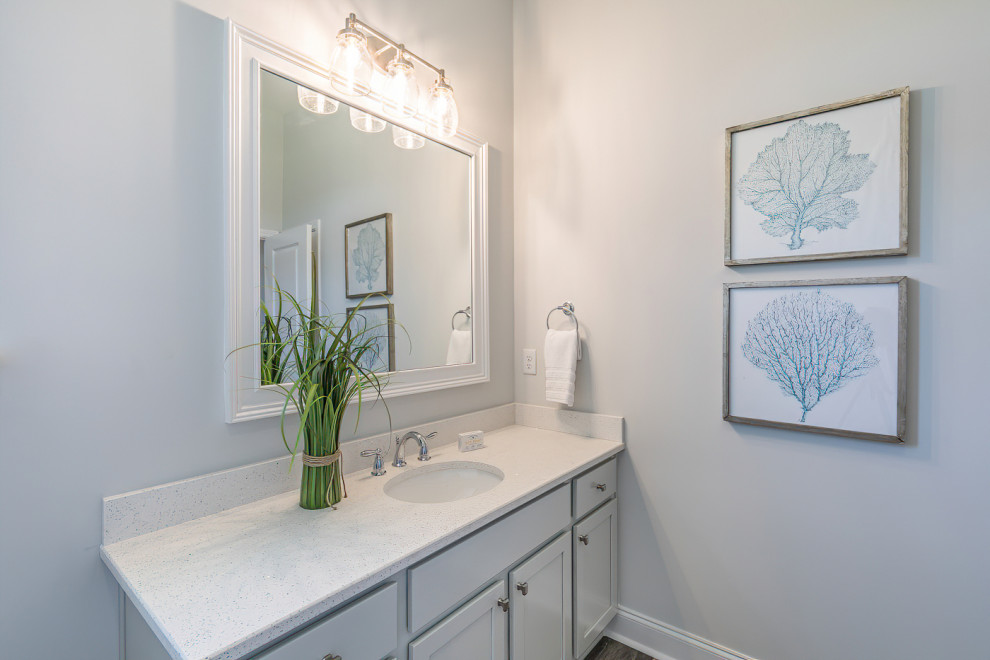 This is an example of a mid-sized modern kids bathroom in Charleston with recessed-panel cabinets, grey cabinets, a shower/bathtub combo, white walls, ceramic floors, a drop-in sink, marble benchtops, grey floor, a shower curtain, white benchtops, a single vanity and a built-in vanity.