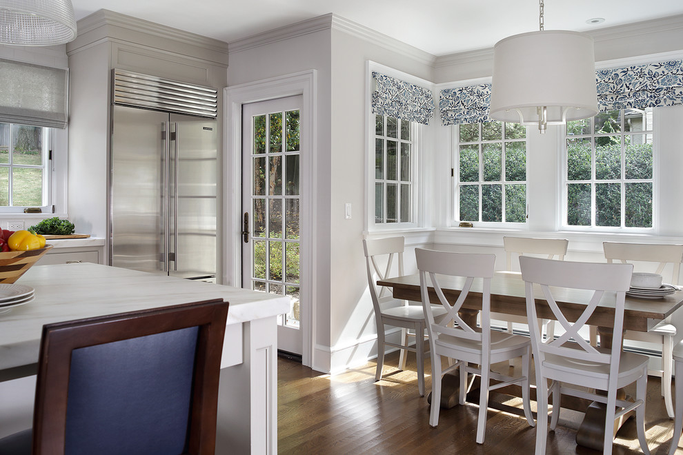 Large transitional l-shaped medium tone wood floor and brown floor enclosed kitchen photo in Newark with an undermount sink, beaded inset cabinets, white cabinets, marble countertops, white backsplash, ceramic backsplash, stainless steel appliances and an island