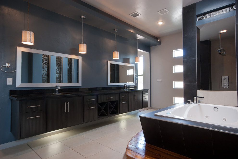 Design ideas for a large modern master bathroom in Austin with flat-panel cabinets, black cabinets, a drop-in tub, an alcove shower, black tile, blue tile, mosaic tile, multi-coloured walls, porcelain floors, a trough sink, solid surface benchtops, white floor and an open shower.