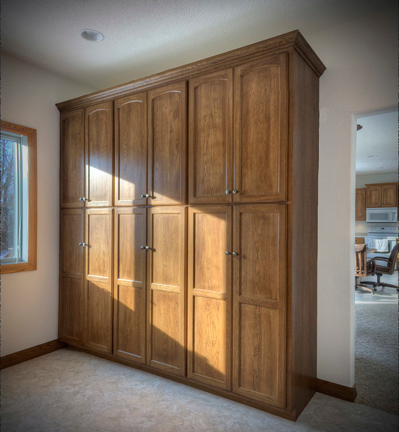 Transitional closet photo with recessed-panel cabinets and light wood cabinets