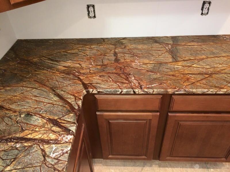 Inspiration for a large rustic l-shaped eat-in kitchen remodel in Indianapolis with an undermount sink, raised-panel cabinets, medium tone wood cabinets, granite countertops, brown backsplash and no island