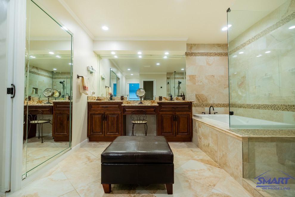 This is an example of a large transitional master bathroom in Houston with dark wood cabinets, a drop-in tub, a shower/bathtub combo, beige tile, granite benchtops, beige floor, raised-panel cabinets, porcelain tile, beige walls, porcelain floors, an undermount sink, a hinged shower door, beige benchtops, a shower seat, a double vanity, a built-in vanity, coffered and a two-piece toilet.
