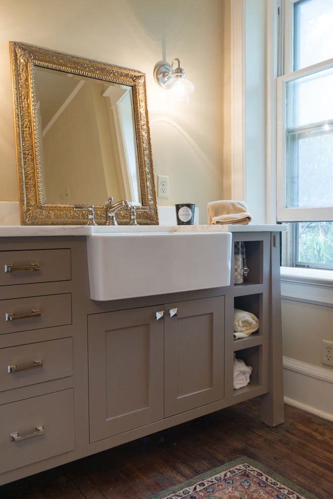 This is an example of a mid-sized arts and crafts master bathroom in Kansas City with a trough sink, flat-panel cabinets, grey cabinets, granite benchtops, beige walls and medium hardwood floors.